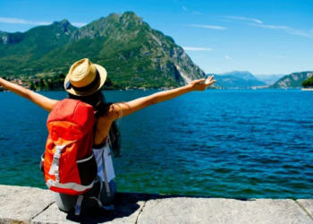 A female traveler looking out on an ocean view.