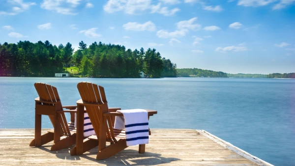 A snapshot of a dock with muskoka chairs