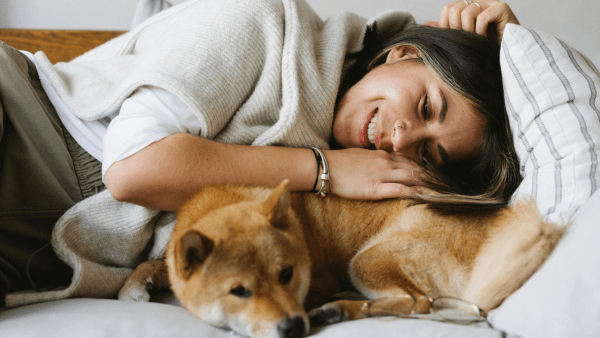 woman cuddling dog
