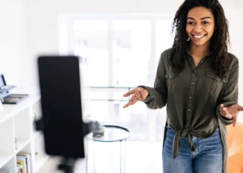 eal estate agent creating social media content on her phone