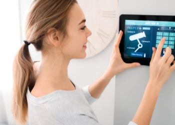 A woman checking a home security system