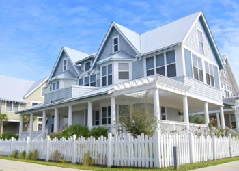 A large house with a white fence