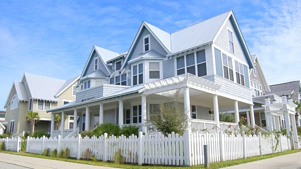 A large house with a white fence