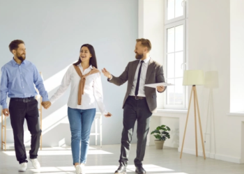 A couple tours a home with a real estate agent.