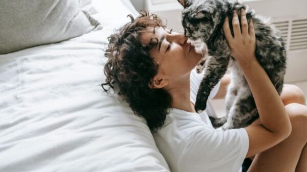 woman cuddling cat
