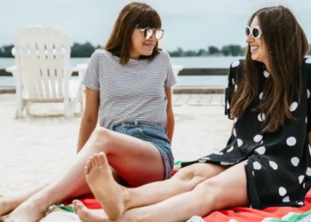 two women chatting on the beach