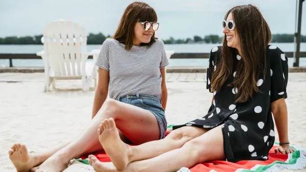 two women chatting on the beach