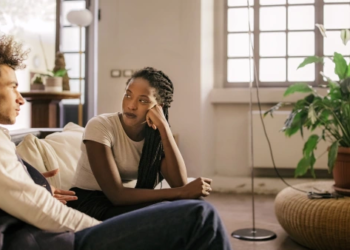 Two roommates speaking in a living room