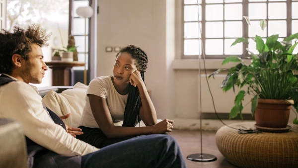 Two roommates speaking in a living room