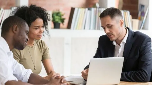 Couple speaking with agent