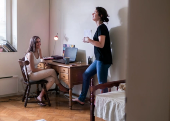 Two roommates talking in a bedroom