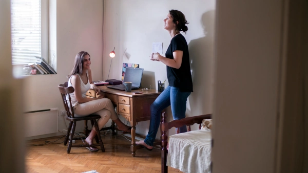 Two roommates talking in a bedroom