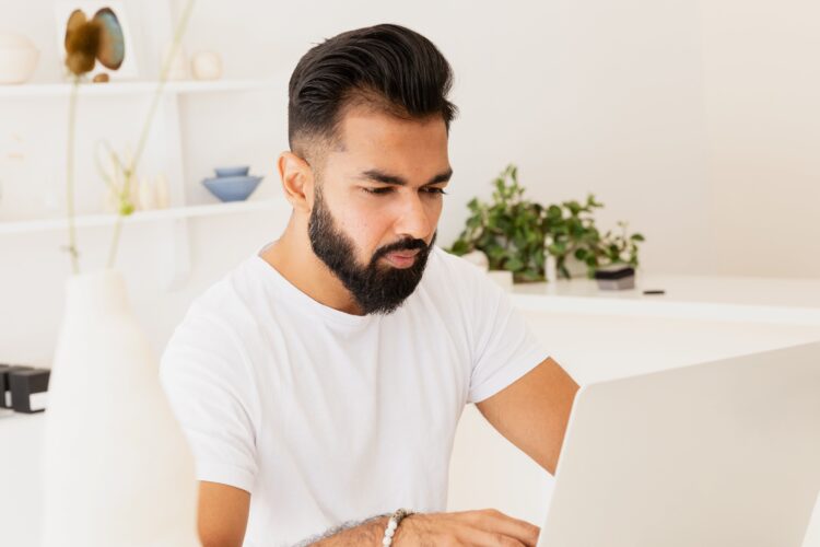 man-in-bright-store-working-on-laptop