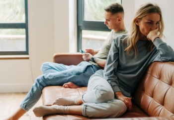 An upset couple in a living room