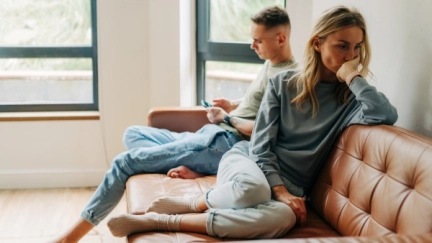 An upset couple in a living room