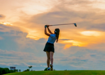 A golfer against a sunset