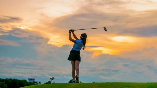 A golfer against a sunset
