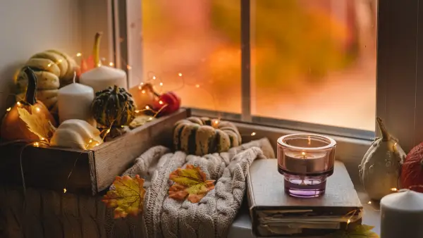 A window sill filled with fall decor.