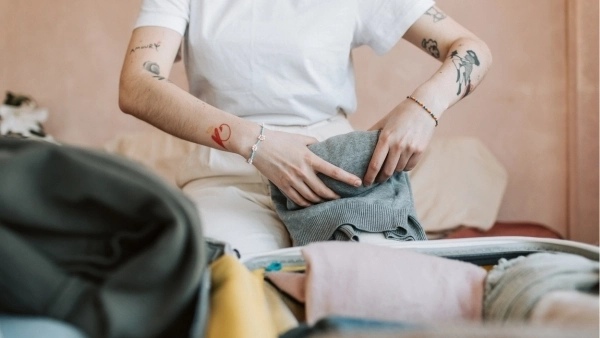 Woman putting clothes away