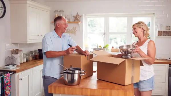 Two people packing up their kitchen together.