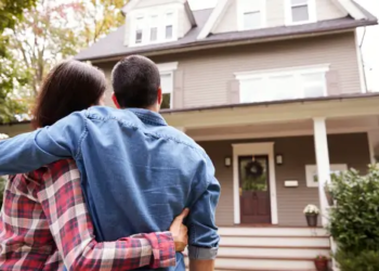 Two people looking at a house together.