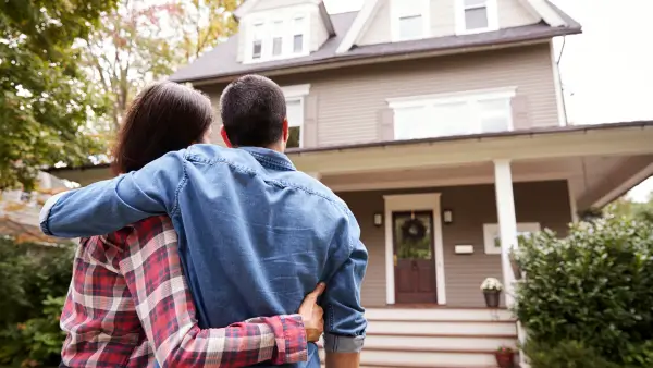 Two people looking at a house together.
