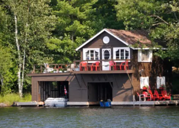 A cottage and boathouse on a lake