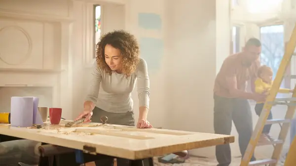 Two people working on fixing up a house.