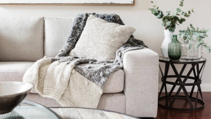 A chunky blanket on a sofa.