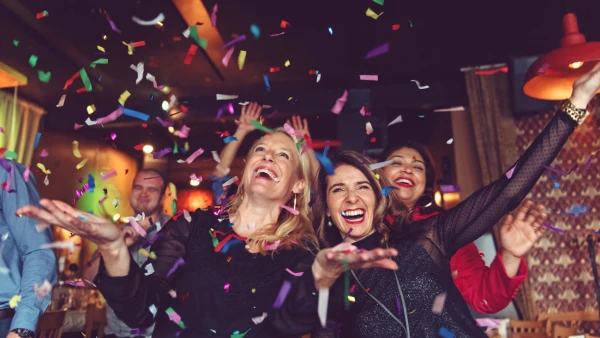 People celebrating NYE with confetti everywhere.