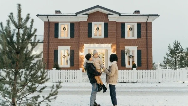 Family outside of house in winter