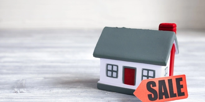 A house with a for sale sign.