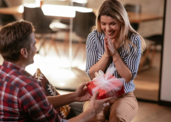 A person gifting a present to someone.