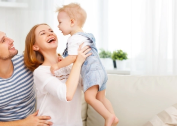 A couple holding a small child