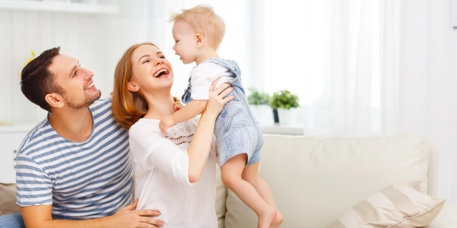 A couple holding a small child