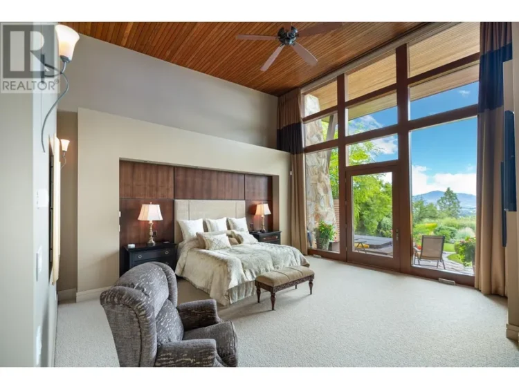 A bright bedroom with a spacious window and a comfortable bed.