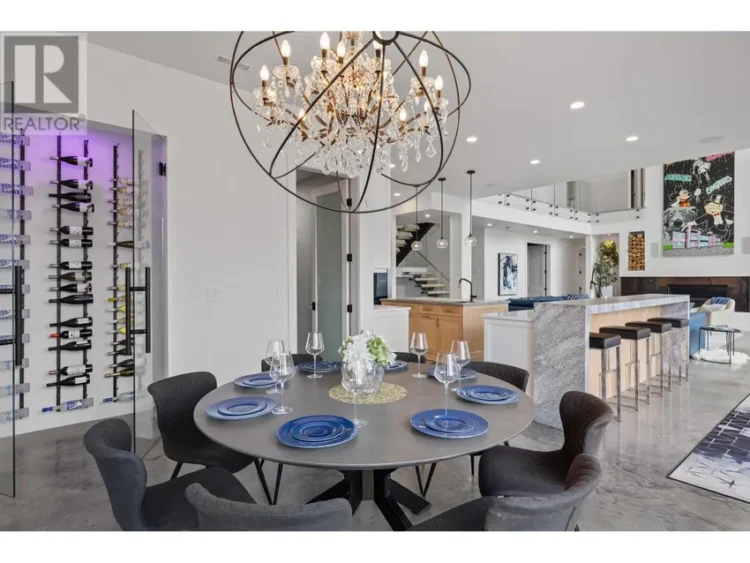 A dining room featuring a chandelier above a set table.