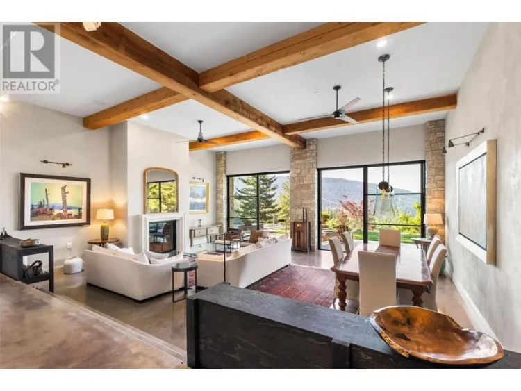 A living room showcasing a fireplace and a spacious window.