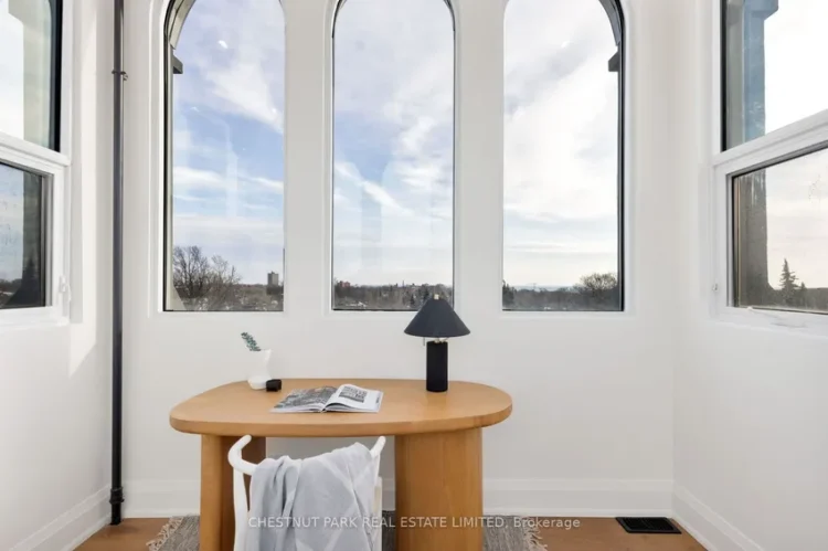 A desk with a lamp and a window, creating a bright and inviting workspace atmosphere.