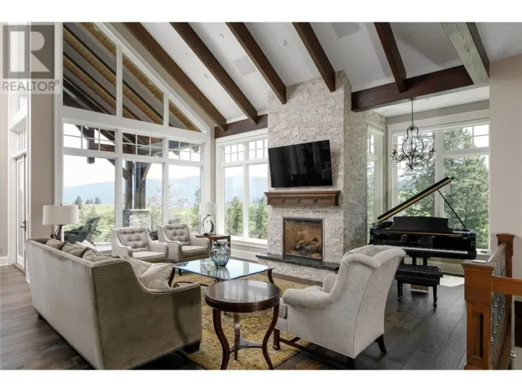 A cozy living room featuring a grand piano beside a warm fireplace.