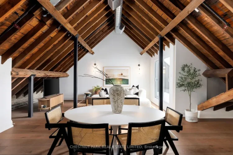 An living room featuring a wooden table surrounded by four chairs.