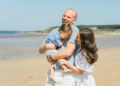 parents and child on the beach