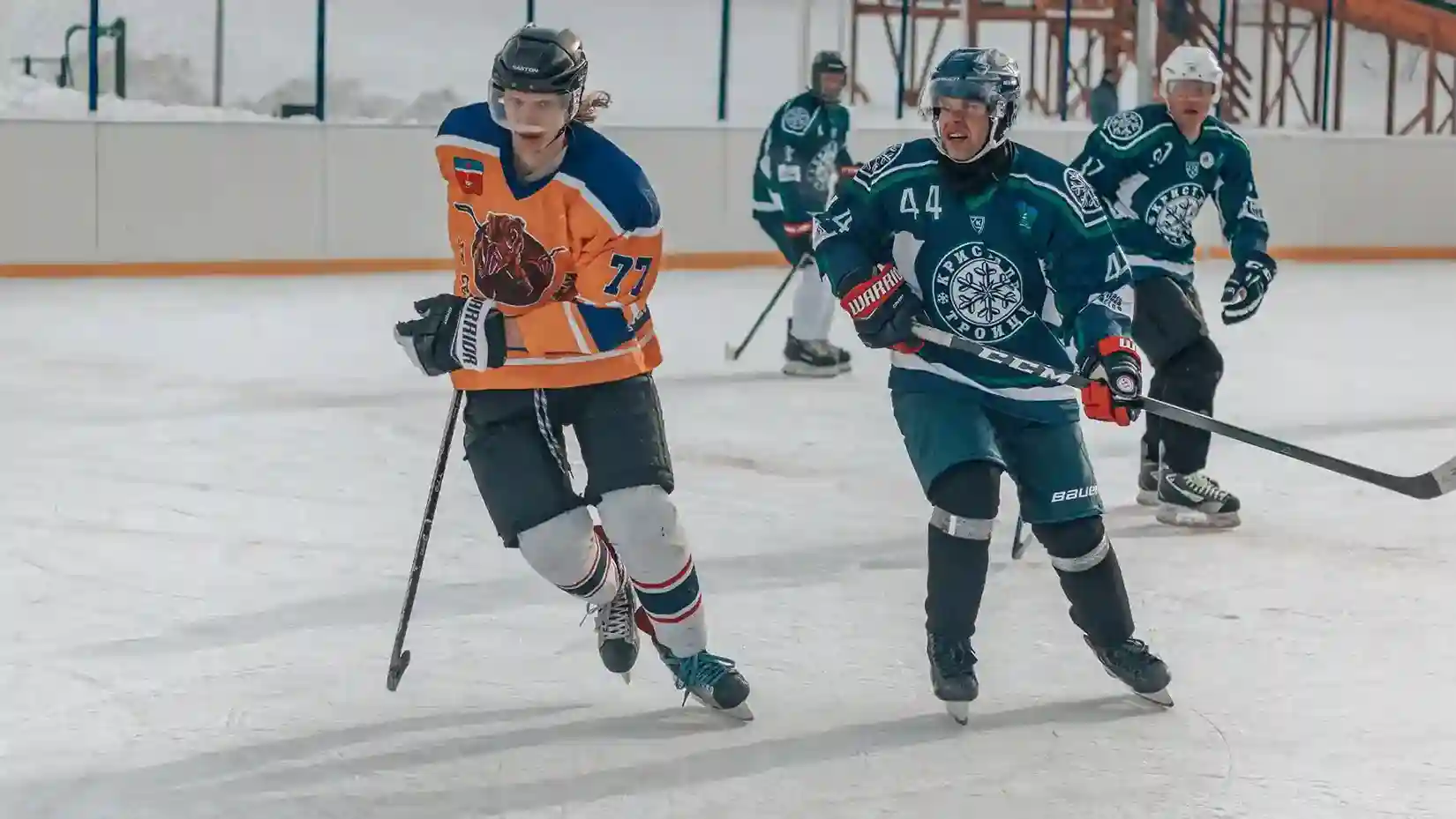 A team of hockey players on an ice rink, playing a competitive game.