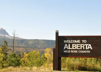 Mountain landscape with a sign that says "Alberta".