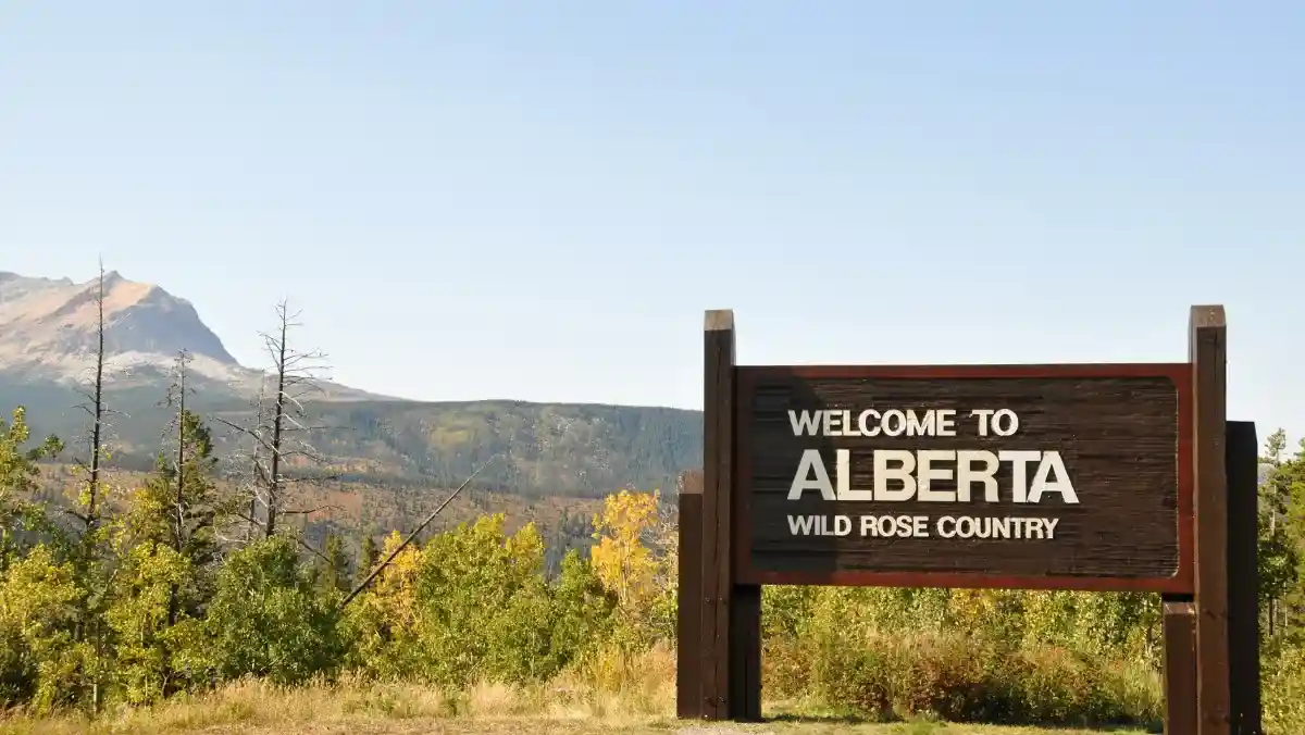 Mountain landscape with a sign that says "Alberta".