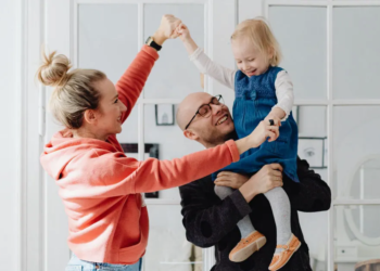 mom and dad holding young child