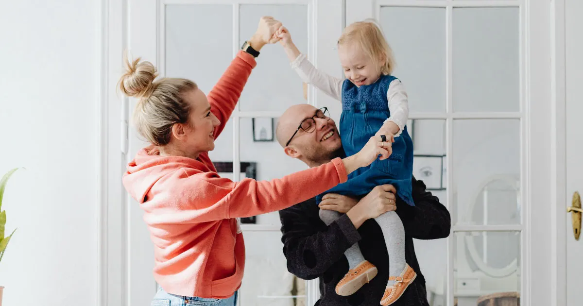 mom and dad holding young child