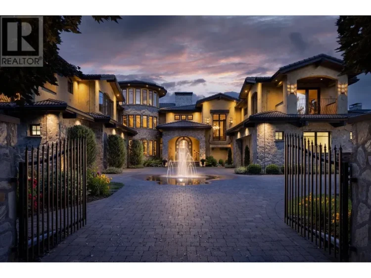A large home with a decorative fountain in front.