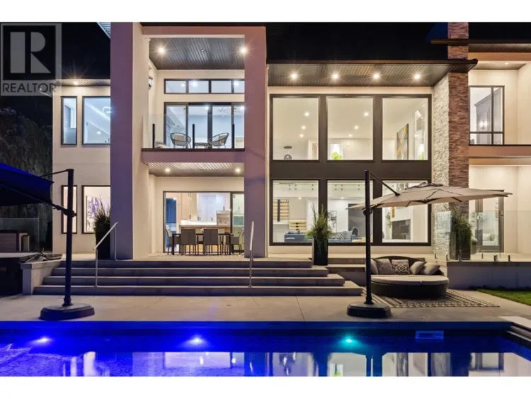 A sleek modern house with a pool and an inviting patio area.
