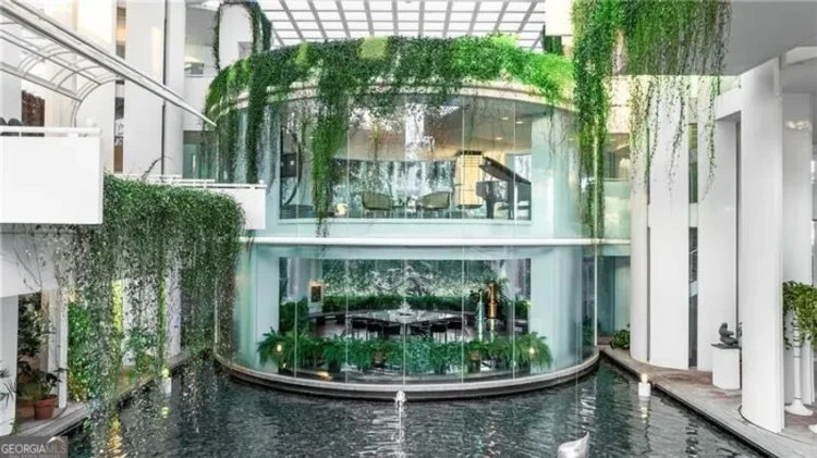 A central fountain surrounded by lush green plants.